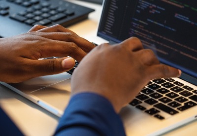 hands typing on a laptop