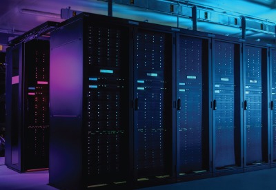multiple servers in a server room with purple light