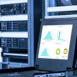 A computer presents various charts in a computer server room.
