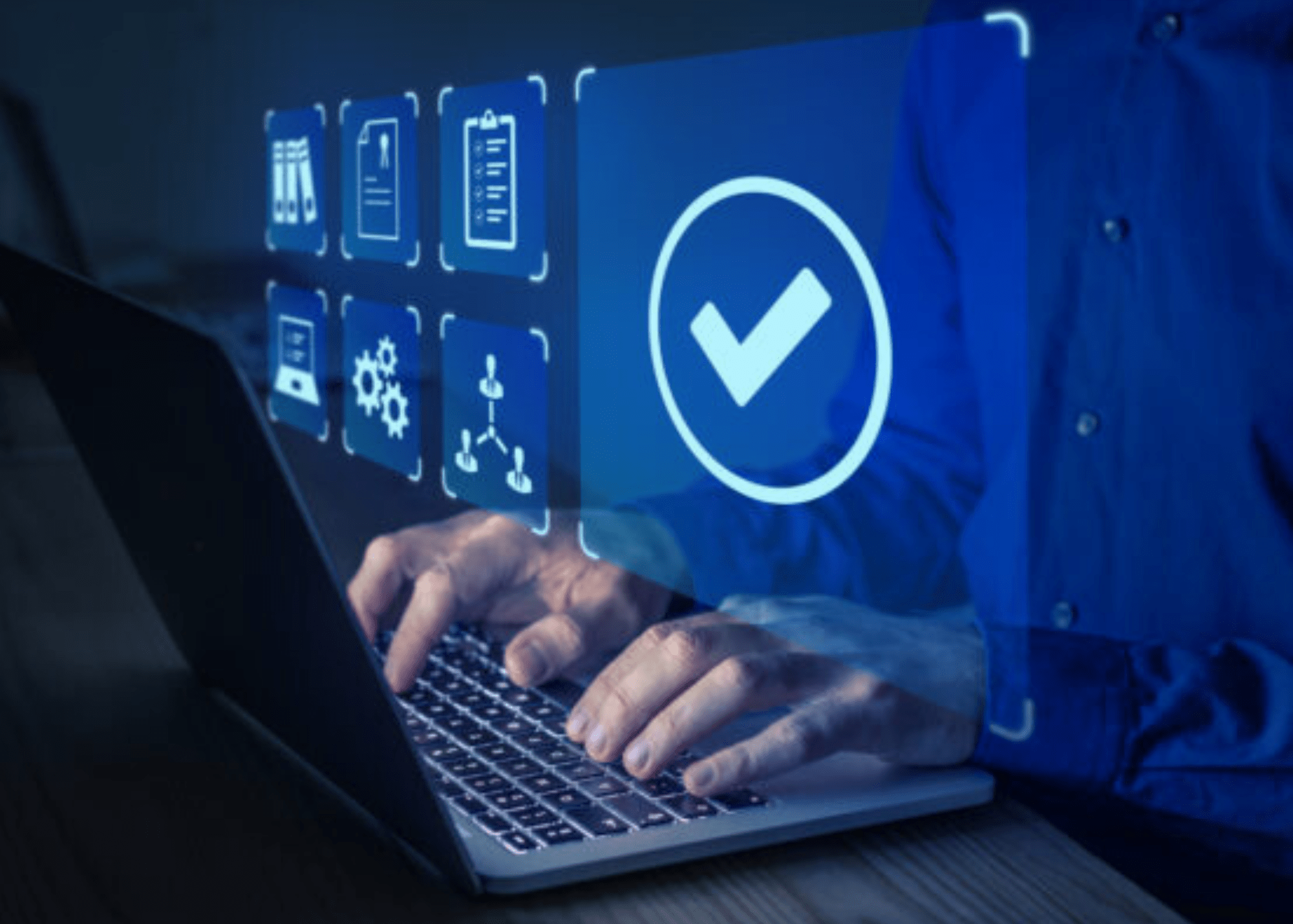 Hands typing on a computer with technology icons