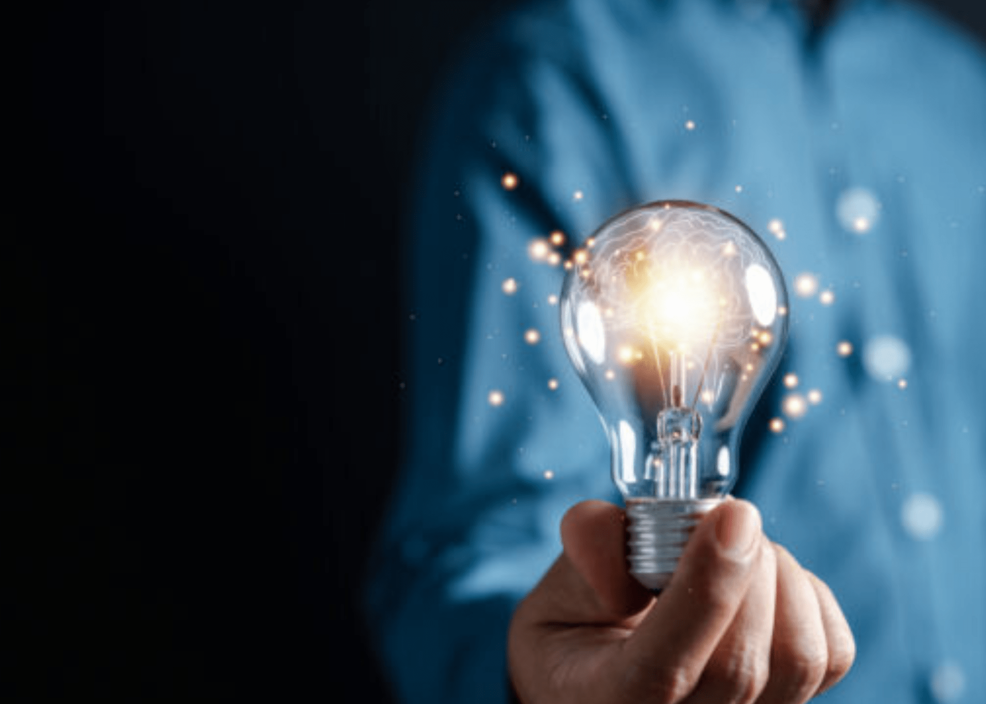 Image of light bulb in a persons hand