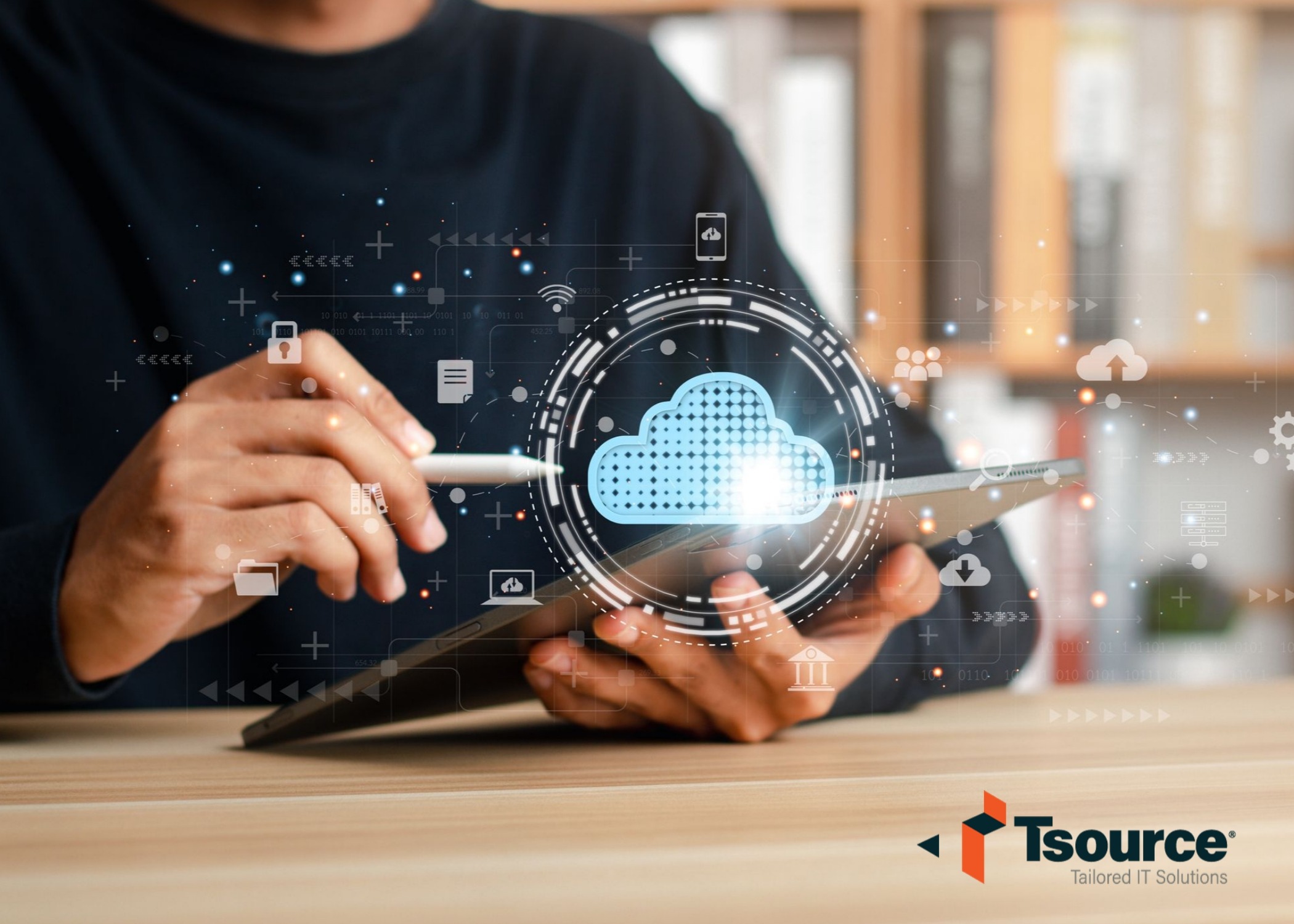 Image of a person holding a tablet with a cloud and technology icons around it.